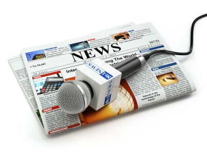 49190850 - news or journalism concept. microphone on the newspaper isolated on white. 3d